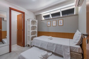 A hotel room with a single bed, a small bedside table, a mirror, and a wardrobe. - Scopa Beach #c5-200 - On the Sand by Carpediem (Aquiraz)