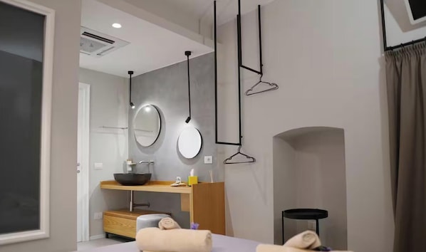 A modern bathroom with a wooden vanity, two round mirrors, a black sink, and a towel rack. - Doña Maria Vacation Home - Luxury Home with a Jacuzzi in the Historic Center of Bari (Bari)