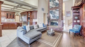 A spacious living area with a large gray sectional sofa, a round coffee table, and a fireplace. - Super Private Vegas Retreat! Close to Strip! (Las Vegas)