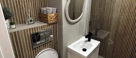 Shower, hair dryer, towels, toilet paper