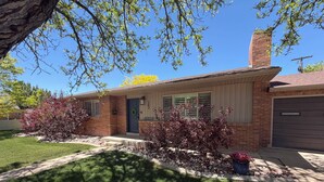 A residential house with a brick facade, a front porch, and a garage.