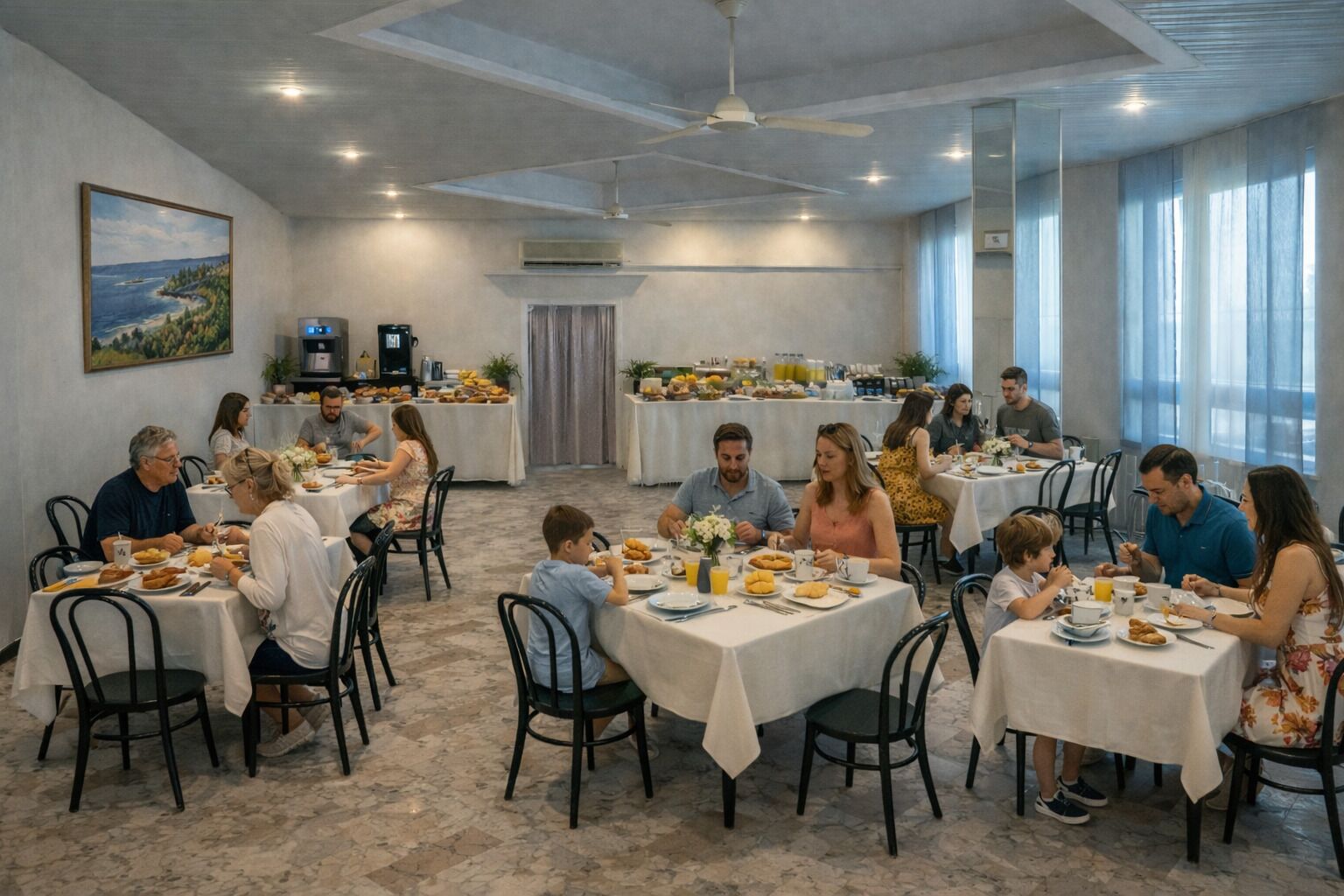 A dining area with round tables, chairs, and a ceiling fan.