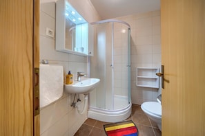 A bathroom with a glass-enclosed shower, a white sink, a toilet, and a mirror above the sink. - A 2 Comfortable apt w Terrace & Garden, Near Beach (Split)