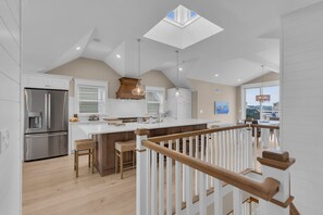 A modern kitchen with a central island, a built-in refrigerator, and a skylight. - BRAND NEW GOLDCOAST SINGLE (Ocean City)