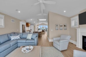 A modern living room with a sofa, armchair, and a fireplace. - BRAND NEW GOLDCOAST SINGLE (Ocean City)