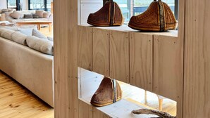 Un interior moderno con paneles de madera, un sofá y cestas tejidas en estantes.