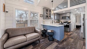 A spacious kitchen with a central island, a sofa, and a dining area. - The Resort at Fredericksburg Unit 1 (Fredericksburg)