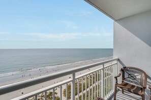 A balcony with a view of a beach and the ocean. - High Floor, Direct Oceanfront Views,Camelot Resort (Myrtle Beach)
