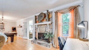 A spacious living room with a stone fireplace, a pool table, and a comfortable seating area. - 3-bedroom house in awesome Ellenwood with cool AC breeze (Ellenwood)