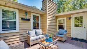 A covered outdoor seating area with a sofa, chairs, and a table. - 3-bedroom house in awesome Ellenwood with cool AC breeze (Ellenwood)