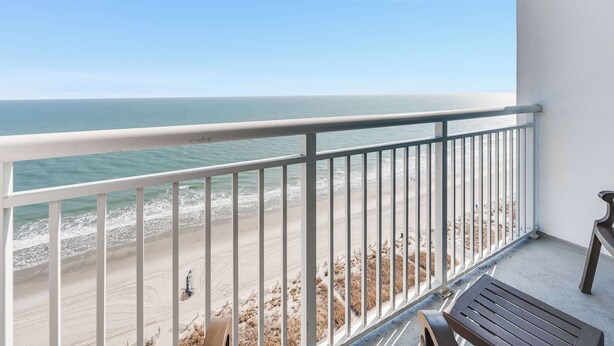 A balcony with a view of the beach and ocean. - Honeymoon Suite with Direct Oceanfront View,Pools! (Myrtle Beach)