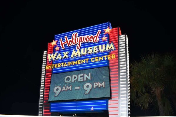 A sign for the Hollywood Wax Museum with the text "OPEN 9AM - 9PM". - Honeymoon Suite with Direct Oceanfront View,Pools! (Myrtle Beach)