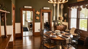 A dining area with a wooden table set for four, surrounded by metal chairs. - Doc Holliday Western Bungalow Walk to Downtown (Denison)
