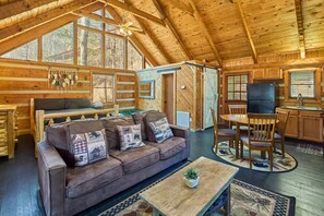 A cozy log cabin interior with a living room, dining area, and kitchen. - Peace, Quiet, and a Cozy Cabin (Sevierville)
