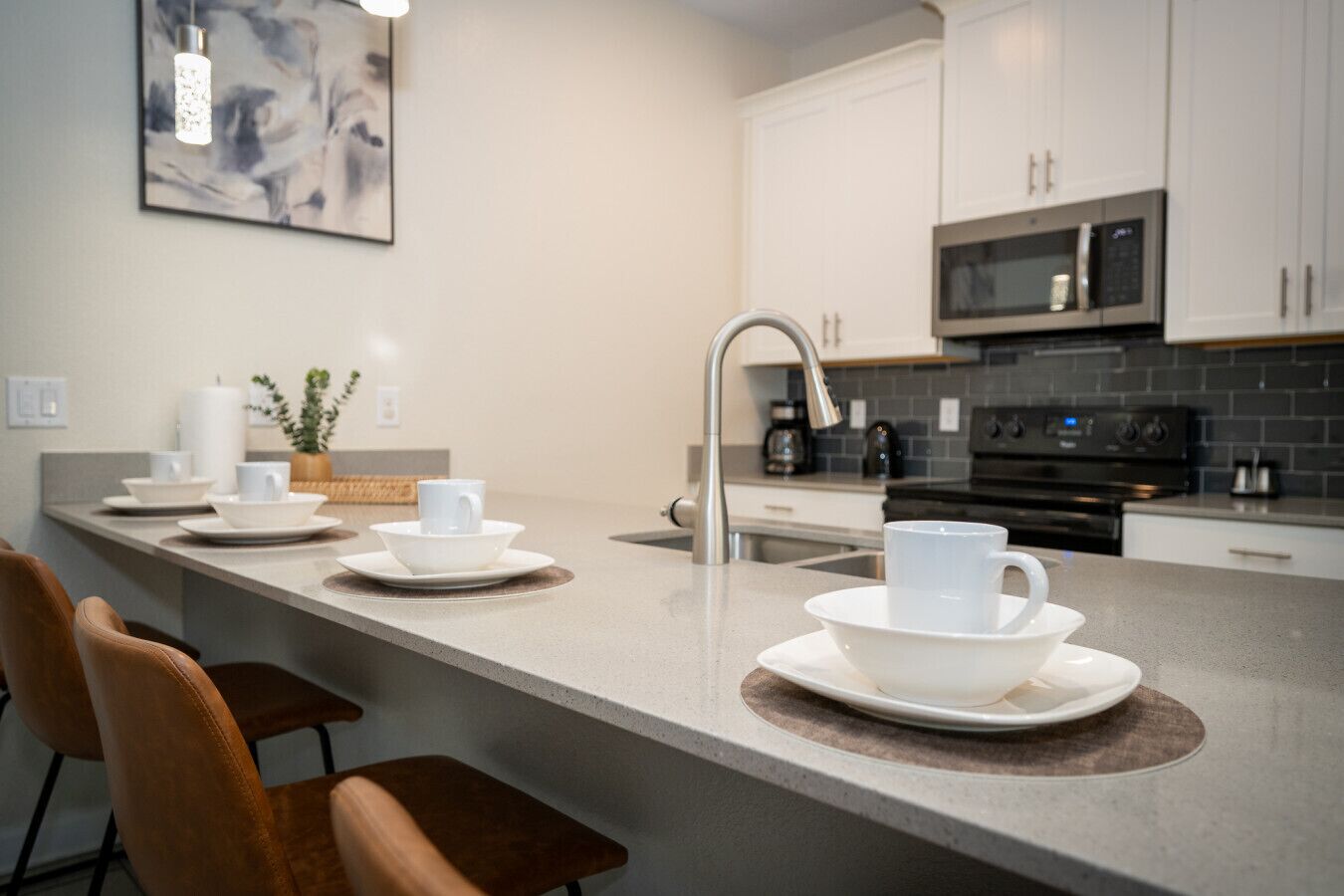A modern kitchen with a central island, stainless steel appliances, and a minimalist design.