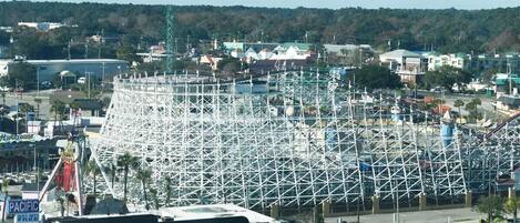 A large amusement park with a prominent roller coaster under construction.