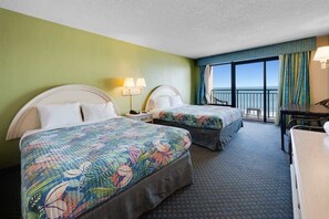 A hotel room with two beds, a desk, and a view of the ocean. - New Direct Oceanfront 8th  Floor, Sandcastle South (Myrtle Beach)