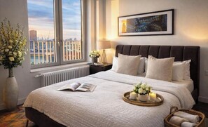 A modern hotel room with a large bed, a view of the city, and a framed artwork on the wall. - Canary wharf iconic London skyline view (London)