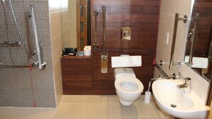 A modern bathroom with a shower, toilet, and sink. - Bicester Country Club (Bicester)