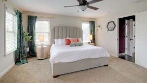 A bedroom with a large bed, a ceiling fan, and a view of the outside through the window. - Pool Table! Walkable Stay in Midtown MEM (Memphis)