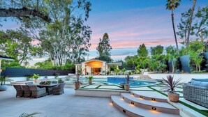 A modern outdoor patio with a pool, outdoor seating, and a covered area. - private resort excusive villa Tarzana south 6500sq with adu pool spa (Los Angeles)