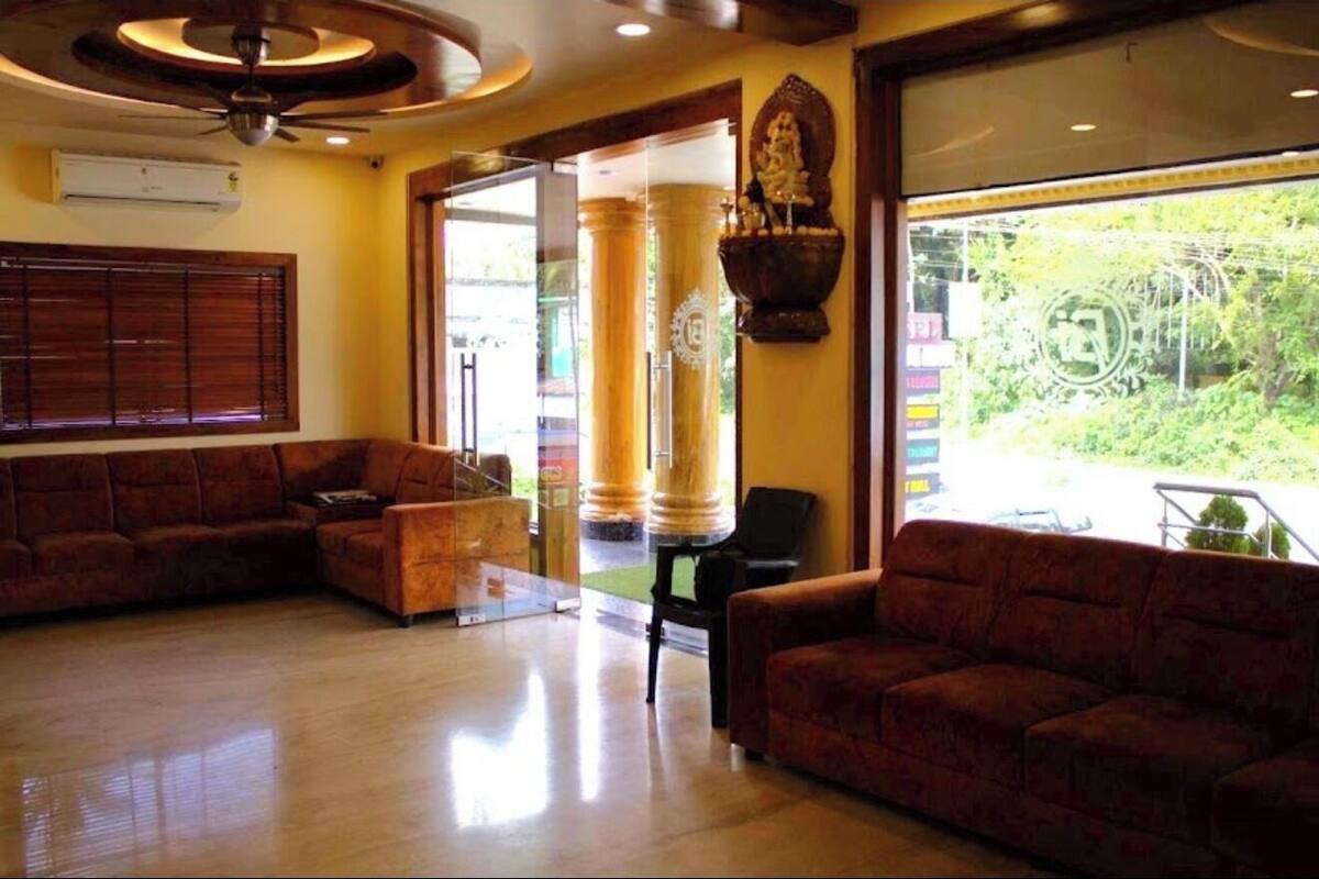 A spacious lobby with a large window, a ceiling fan, and a statue.