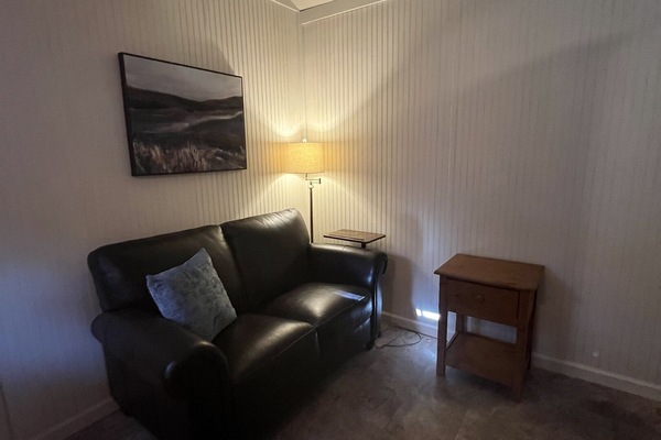 Comfortable love seat faces the Smart TV.