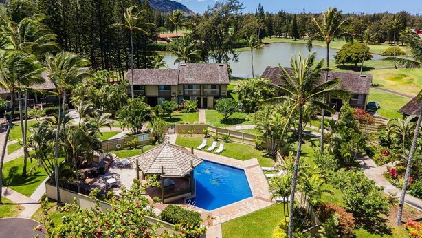 A resort with a swimming pool, a golf course, and lush greenery. - Spacious 4-bedroom condo in gorgeous Kahuku with AC (Kahuku)