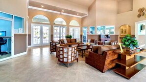 A spacious lobby with a seating area, a reception desk, and large windows. - Near Disney~Private Patio~Family~Bella Vida Resort (Kissimmee)