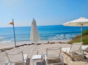 A beachside view with four white lounge chairs and two umbrellas, overlooking the ocean. - EXCLUSIVE APARTMENT IN PUNTA DE MITA (Corral del Risco)