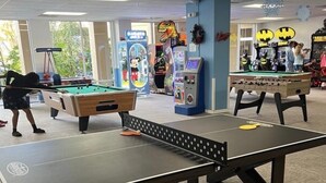 A recreational area with a foosball table, pool table, and arcade games. - Summer Disney Getaway, 2BR/2BA, sleeps 6, June 18-21, Resort Pool (Kissimmee)