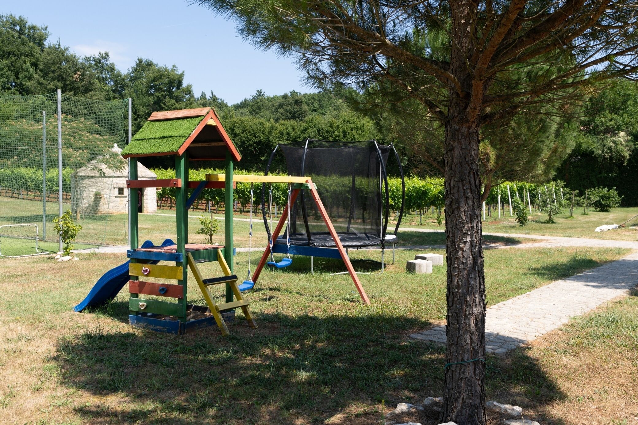 A playground with a slide, swing set, and climbing structure.