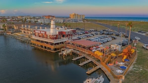 A waterfront restaurant with outdoor seating and a dock. - Y Knot Go to the Beach! Cute Beach Condo (Corpus Christi)