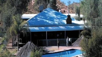 A building with a large pool and a covered area.