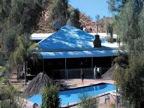 A building with a large pool and a covered area.
