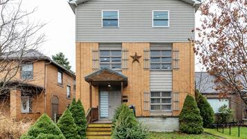 A two-story building with a central entrance, a star decoration above the door, and a brick facade.