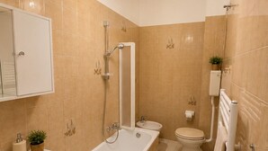 Ein modernes Badezimmer mit Badewanne, Waschbecken, Toilette und Dusche.