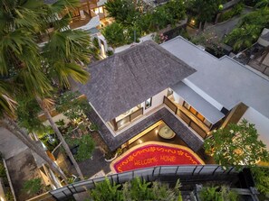 An aerial view of a hotel with a rooftop terrace, indoor seating area, and lush greenery. - Kanadea Villa Canggu By Inivie (Payangan)