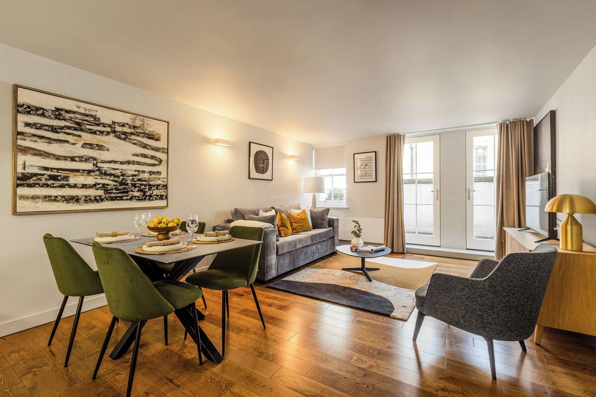 A modern living room with a dining area, a sofa, and a coffee table.