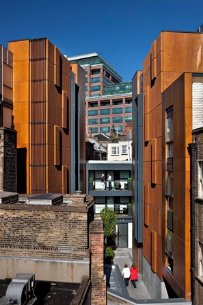 A modern building with a brick facade and a wooden panel design. - Liverpool Street - Your Apartment (London)