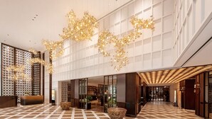A spacious lobby with a geometric tile floor, a reception desk, and a modern chandelier. - Grand Skylight International Hotel Jinan (Jinan)