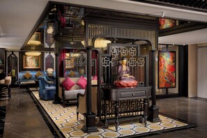 A traditional Asian-style interior with a Buddha statue, ornate wooden screens, and a patterned floor. - Tonkin Luxury Boutique Hotel & Spa (Hanoi)