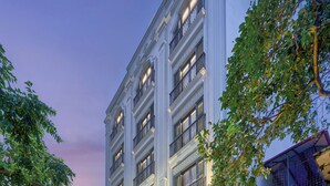 A multi-story hotel with a classic facade, large windows, and a well-lit entrance. - Tonkin Luxury Boutique Hotel & Spa (Hanoi)