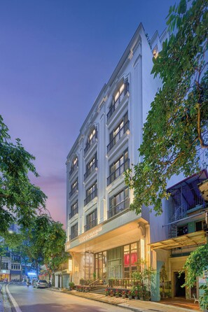 A multi-story hotel with a classic facade, large windows, and a well-lit entrance. - Tonkin Luxury Boutique Hotel & Spa (Hanoi)