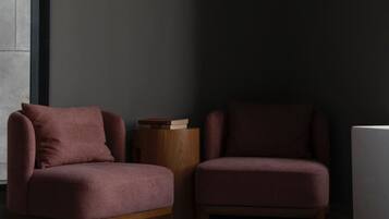 A room with two armchairs and a small wooden side table.