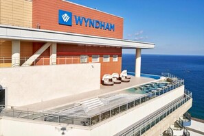 Cubierta de crucero con piscina, sillas de descanso y el logotipo de Wyndham.