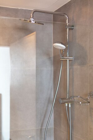 A shower with a handheld showerhead and a wall-mounted faucet. - Liv Weibdeh Hotel Suites (Amman)