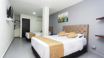 A hotel room with a large bed, a smaller bed, a TV, and a painting on the wall.