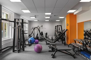 A gym with various exercise equipment, including weight machines, free weights, and exercise balls. - Grandhotel Nabokov Spa & Wellness (Marianske Lazne)