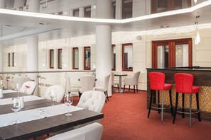 A hotel lobby with a dining area, bar, and seating. - Grandhotel Nabokov Spa & Wellness (Marianske Lazne)